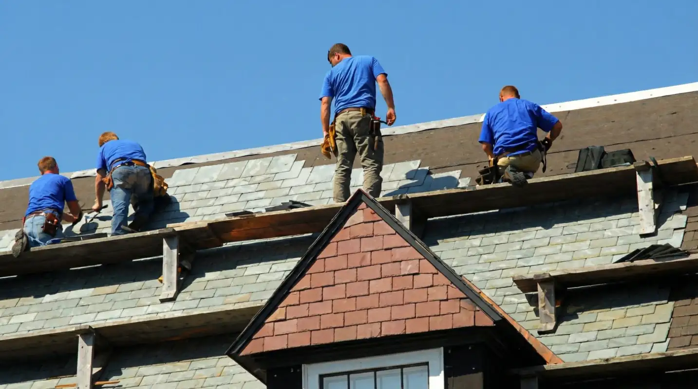 Roof replacement in progress with a team of professional contractors installing new shingles on a residential home in Spokane, WA